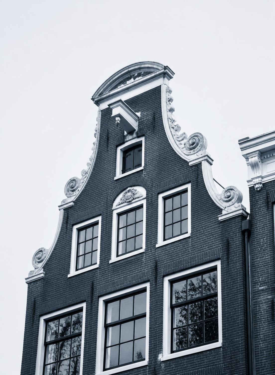 Amsterdam canal houses seen from below at dusk
